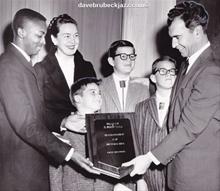 Dave Brubeck receives a Brotherhood Day award from Berkeley YMCA Phalanx Club, as Iola, Chris 7; Darius 12, and Michael 10, look on.