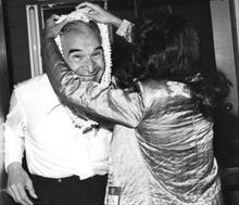 Hawaii jazz host Heidi Chang presenting a pikake flower lei to Dave  in 1981